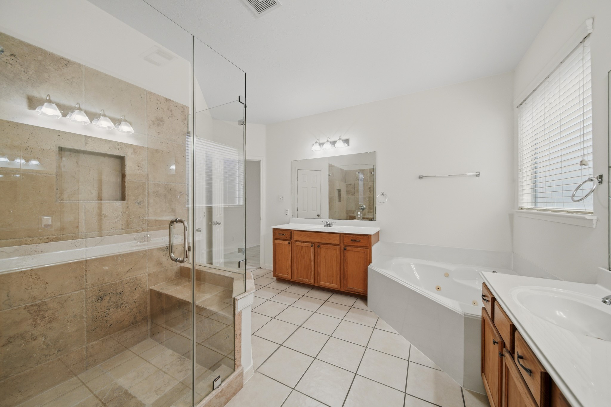 3306 Colleville Sur Mer Lane Spring, TX 77388 - Photo 12 of 30 The oversized glass-enclosed shower features elegant tile finishes and provides a separate space for a refreshing start to the day.