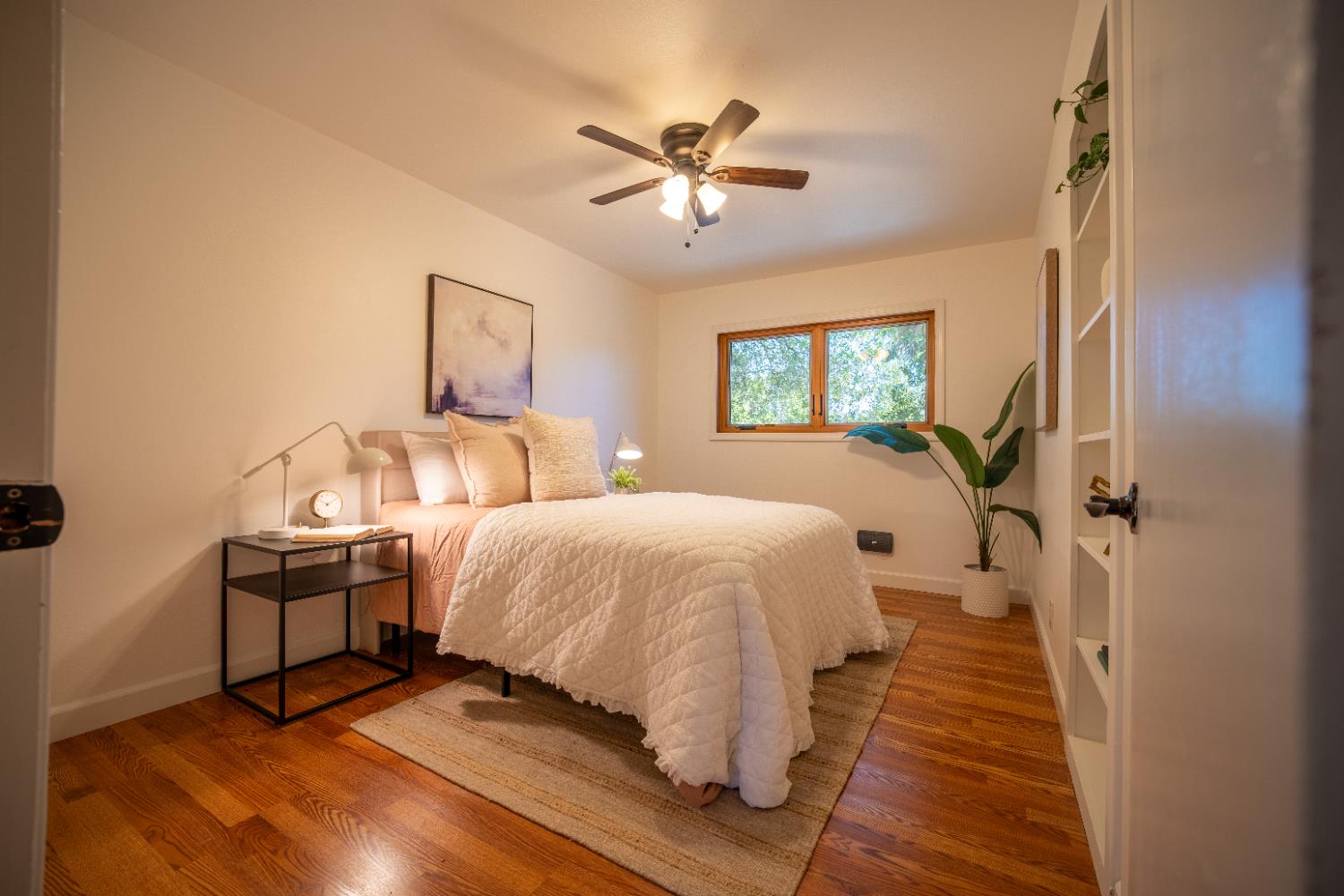 4220 Elva Way Sacramento, CA 95821 - Photo 21 of 52 a spacious bedroom with a bed and a chandelier