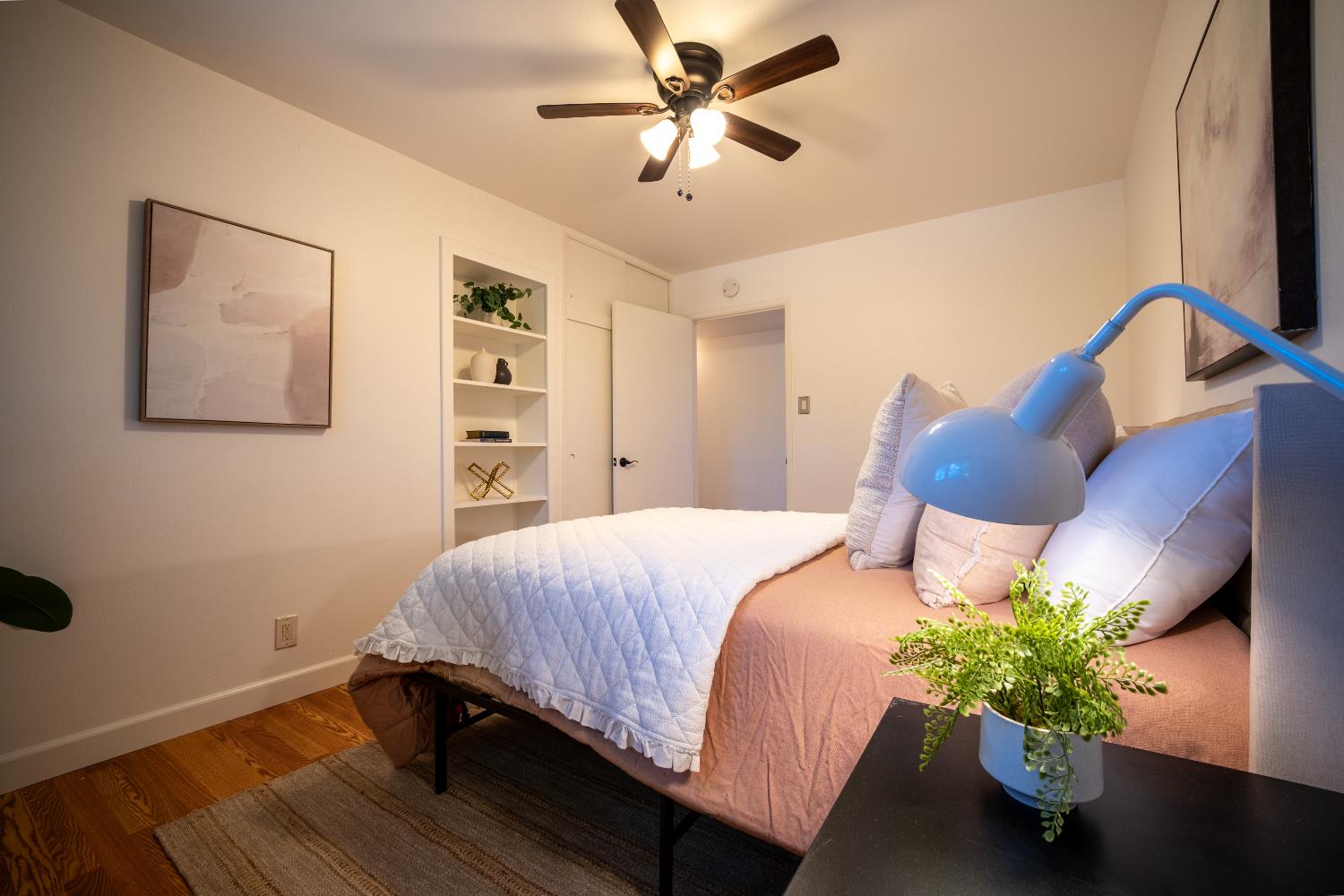 4220 Elva Way Sacramento, CA 95821 - Photo 23 of 52 a bedroom with a bed table and a potted plant