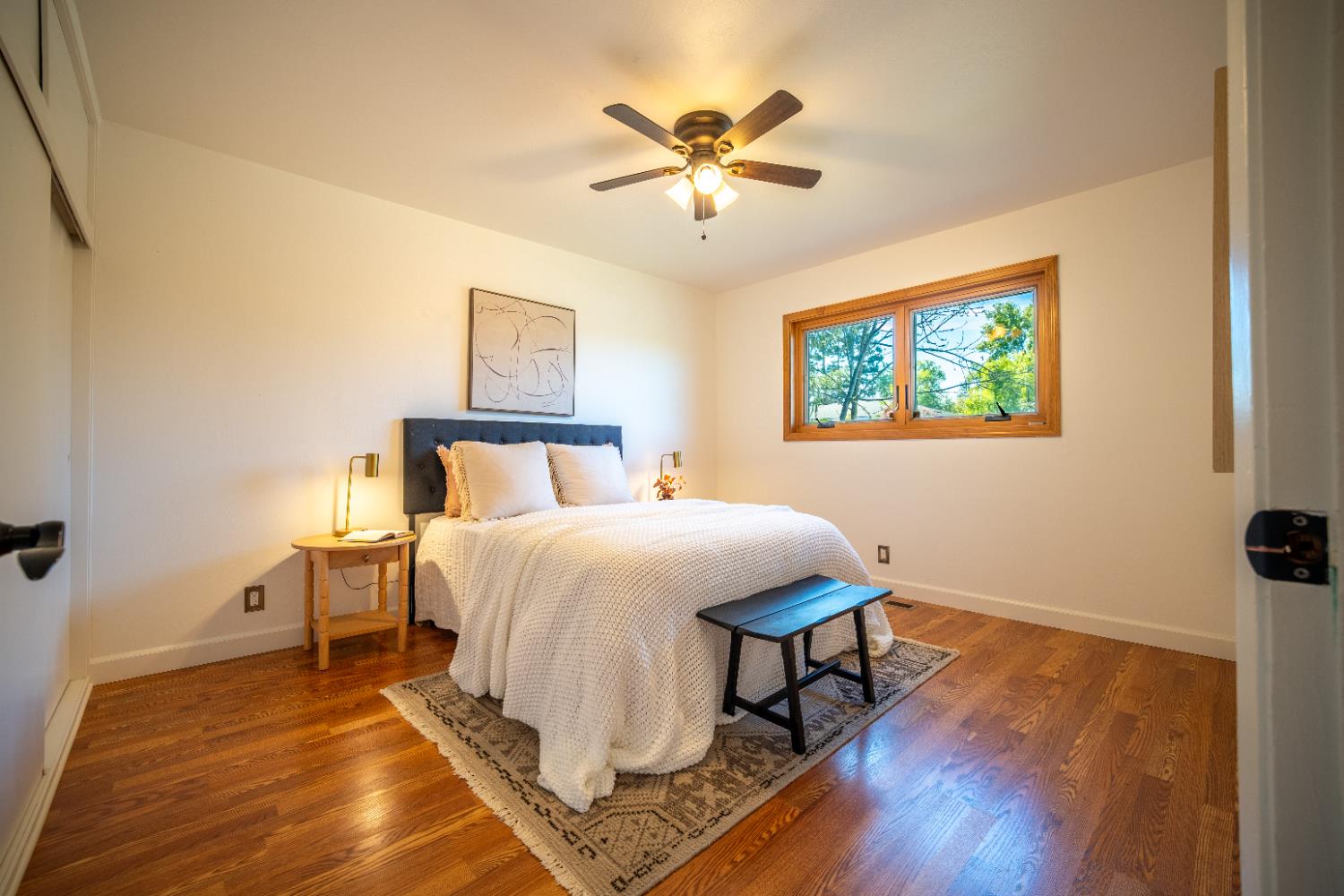 4220 Elva Way Sacramento, CA 95821 - Photo 27 of 52 a bedroom with a bed and a table with wooden floor