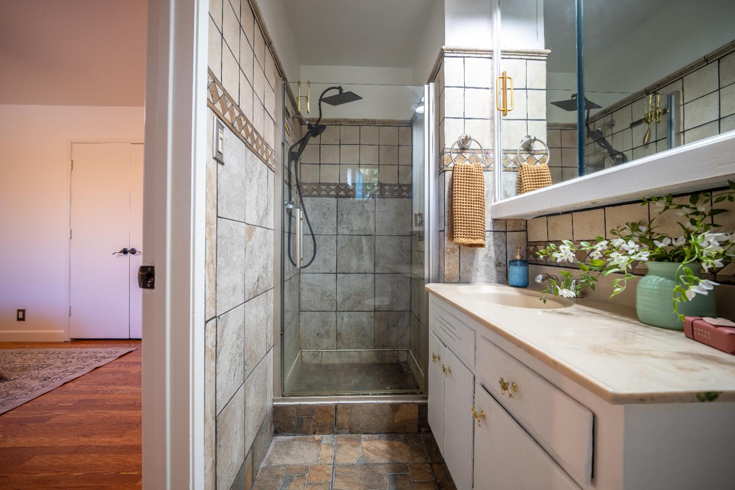 4220 Elva Way Sacramento, CA 95821 - Photo 33 of 52 a bathroom with a granite countertop shower a mirror and a sink