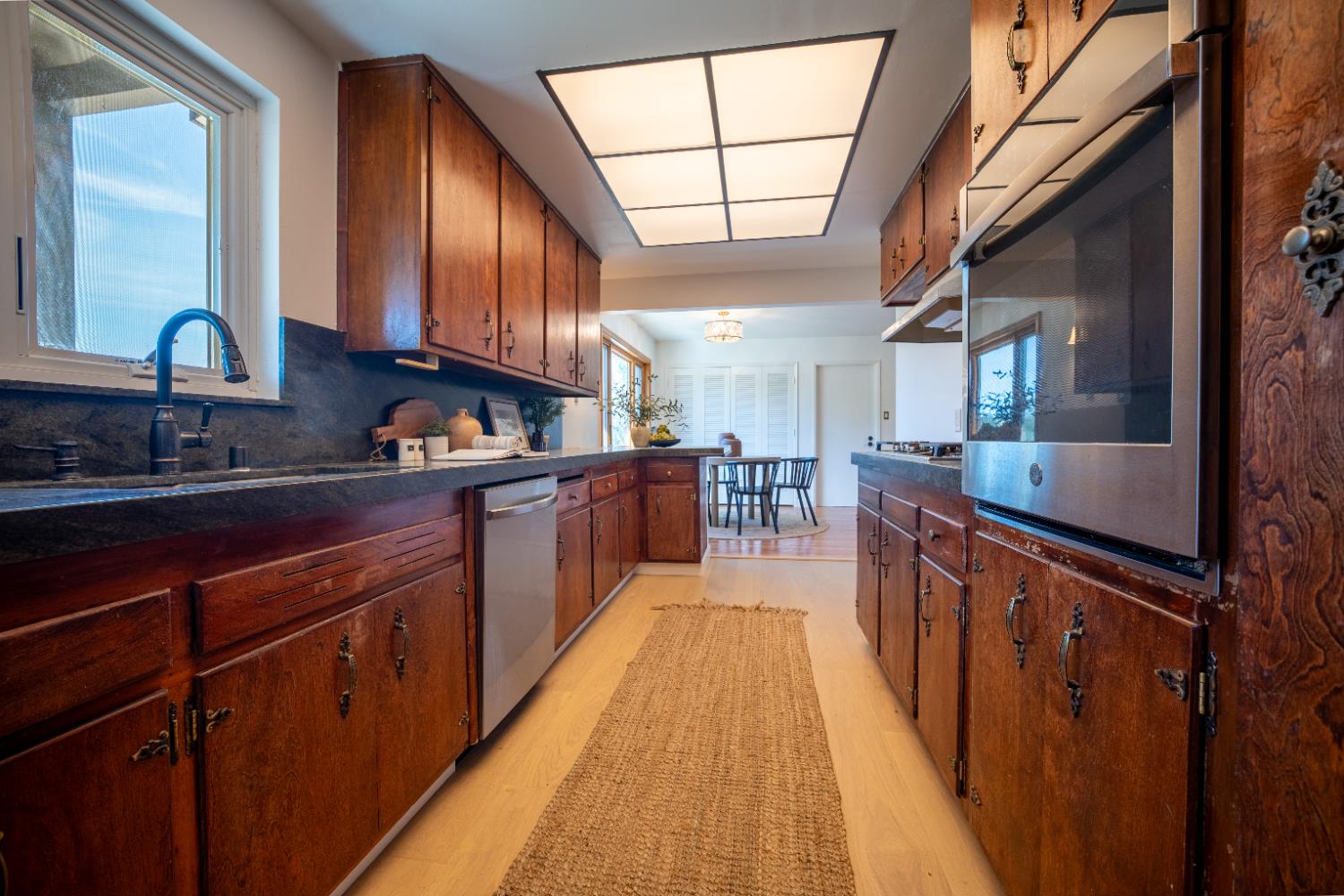4220 Elva Way Sacramento, CA 95821 - Photo 5 of 52 a kitchen with stainless steel appliances granite countertop lots of counter top space and wooden floor