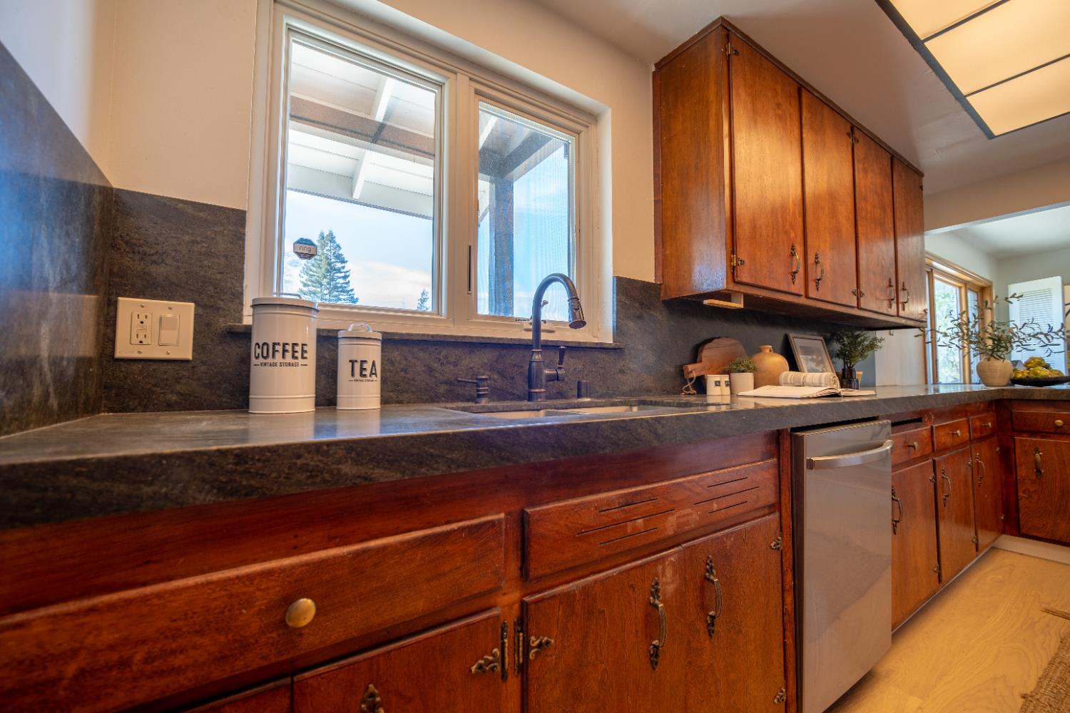 4220 Elva Way Sacramento, CA 95821 - Photo 6 of 52 a kitchen with stainless steel appliances a sink dishwasher and cabinets next to a window