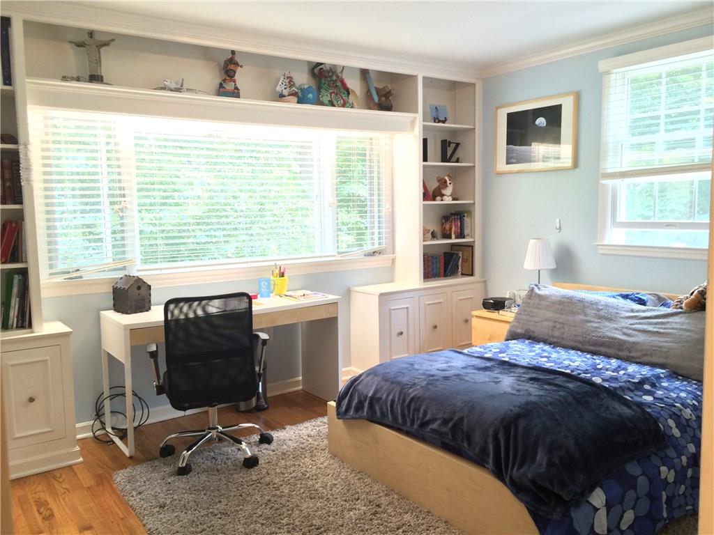 406 Buckingham Road Fox Chapel, PA 15215 - Photo 15 of 25 This bright bedroom is filled with dappled sunlight most of the day from the generous windows on two sides. Built-ins and oak floors accent the space.