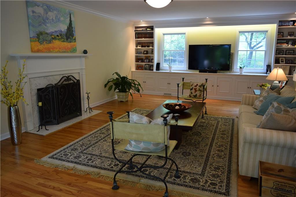 406 Buckingham Road Fox Chapel, PA 15215 - Photo 5 of 25 Classic white built-ins topped with Carrera marble complement the fireplace and provide amble storage and display space.