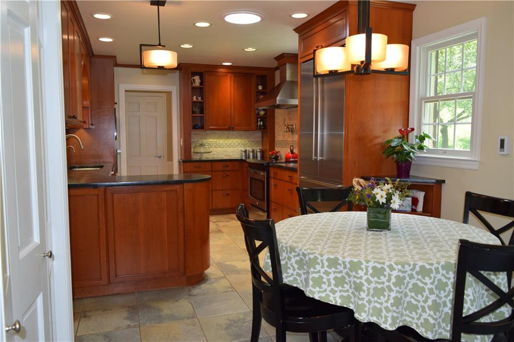 406 Buckingham Road Fox Chapel, PA 15215 - Photo 8 of 25 The beautiful custom made cherry cabinetry was hand made by Kelly Custom Furniture of Lawrenceville. If you like to cook, you'll love the induction range: it's faster, cleaner, safer and more energy efficient than gas. (But if you prefer a gas range, switching is easy: there's a capped gas line below the range). A large true convection oven, warming drawer, professional Vent-A-Hood range hood and pot filler faucet fulfill a cooking aficionado's wish list. The Solatube skylight enhances the natural lighting.