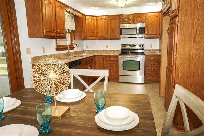 223 East Union Road Cheswick, PA 15024 - Photo 7 of 25 Kitchen and Dining Room are Open Concept. Floating Vinyl Core-Tech Flooring and newer Oak Cabinetry was installed around 2006. Light blue walls lighten the space along with Accent Lighting near cabinets and in Dining Room.