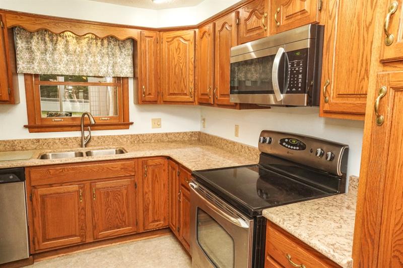 223 East Union Road Cheswick, PA 15024 - Photo 8 of 25 Kitchen offers VanGura Granite Countertops approximately 6 years old, A Double Bowl Sink with Pull Down Faucet, Above Sink Lighting and Stainless Steel Electric Stove, LG Microwave and GE Dishwasher.