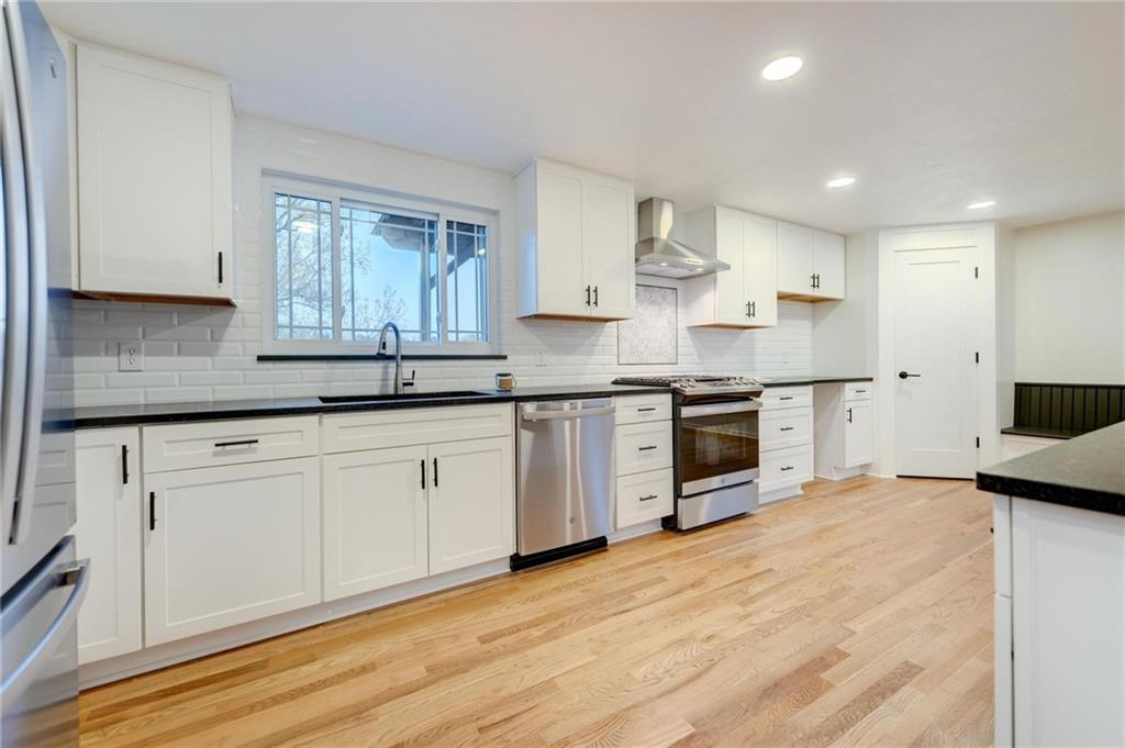 18 Seneca Road Pittsburgh, PA 15241 - Photo 2 of 25 a kitchen with stainless steel appliances granite countertop a stove a sink and white cabinets