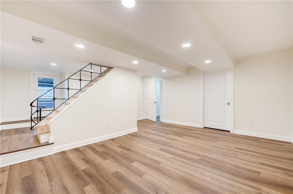 18 Seneca Road Pittsburgh, PA 15241 - Photo 21 of 25 a view of an empty room with wooden floor and stairs