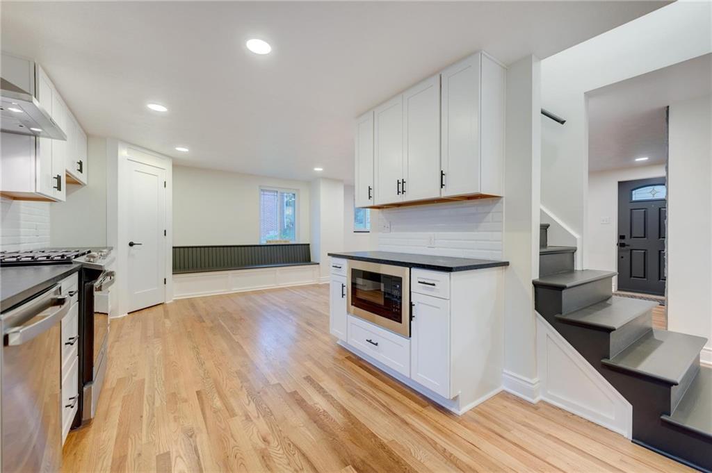 18 Seneca Road Pittsburgh, PA 15241 - Photo 8 of 25 a kitchen with stainless steel appliances a stove a sink and white cabinets with wooden floor