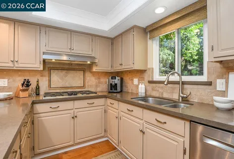 a bathroom with a granite countertop toilet sink and mirror