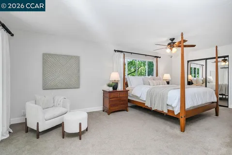 a view of kitchen with kitchen island white cabinets and chandelier
