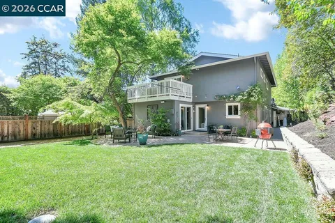 a view of backyard of house with green space