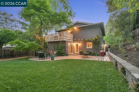 a view of a chairs and table in backyard of the house