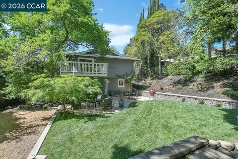 a backyard of a house with table and chairs