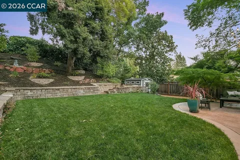a backyard of a house with table and chairs