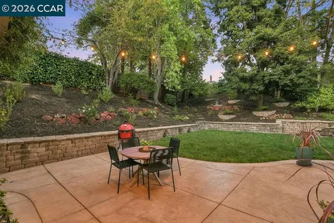 a view of a house with a yard and tree s