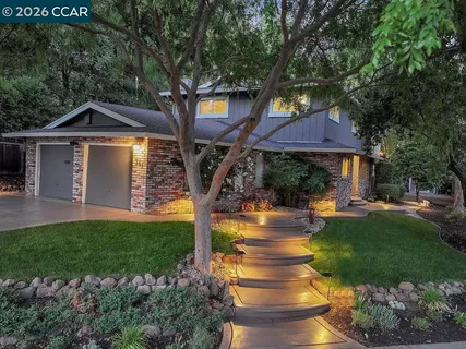 an aerial view of a house with yard and outdoor seating
