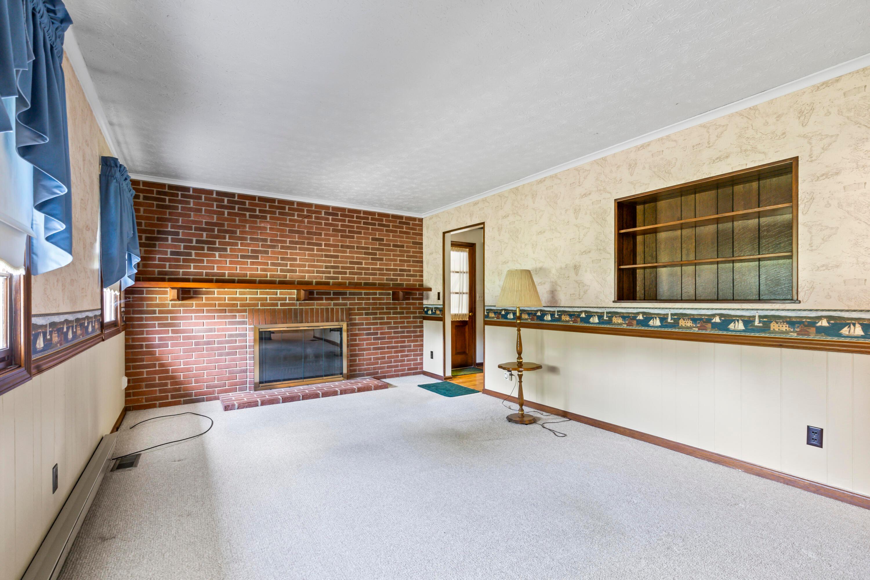 5764 Cheshire Road Galena, OH 43021 - Photo 5 of 59 • Berber carpet
• Papered & panelled walls
• Chair railing
• Crown molding
• Brick fireplace with mantle
& raised hearth