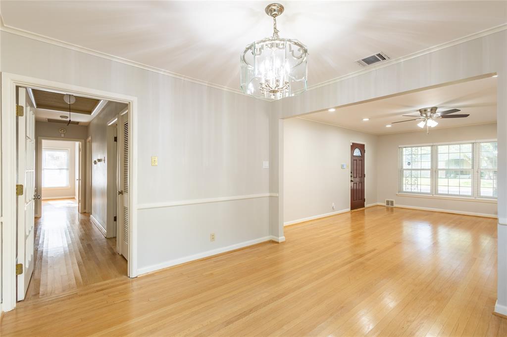 6165 Ravendale Lane Dallas, TX 75214 - Photo 11 of 40 a view of an empty room with wooden floor and a window