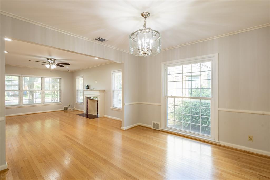6165 Ravendale Lane Dallas, TX 75214 - Photo 12 of 40 a view of an empty room with wooden floor and a window