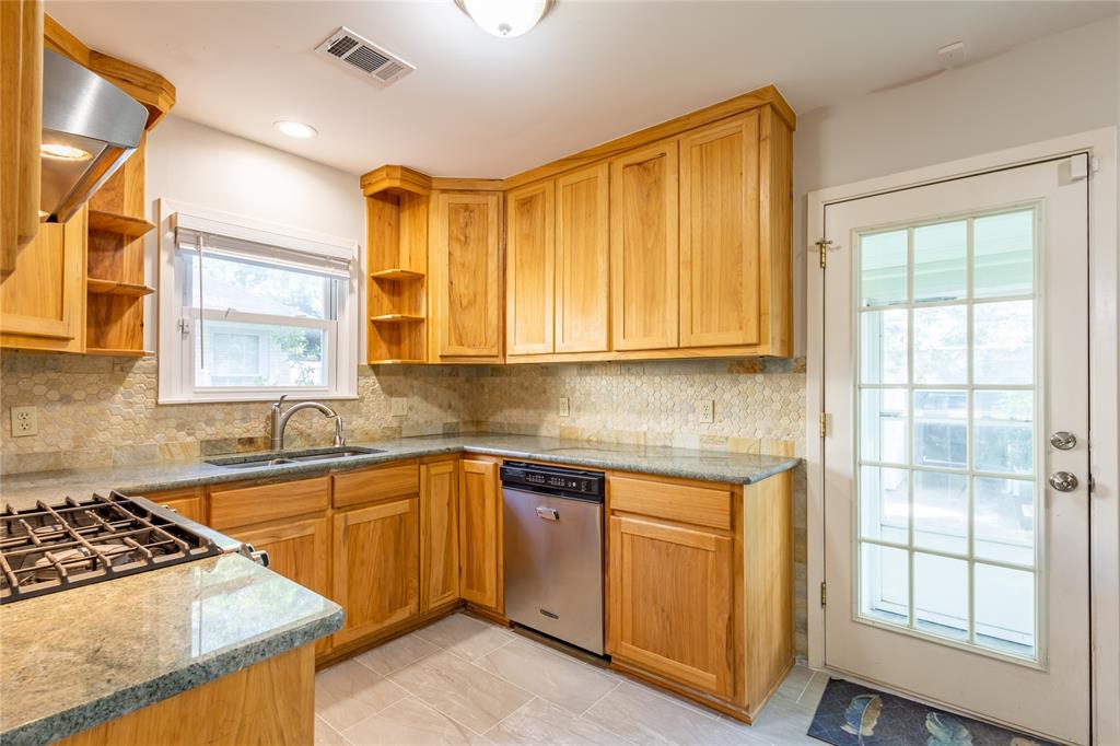 6165 Ravendale Lane Dallas, TX 75214 - Photo 13 of 40 a kitchen with a sink stove and cabinets