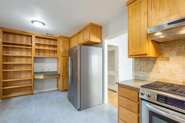 a kitchen with a refrigerator and a stove