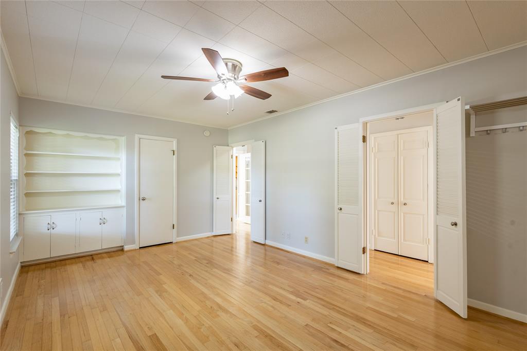 6165 Ravendale Lane Dallas, TX 75214 - Photo 22 of 40 an empty room with wooden floor and closet area