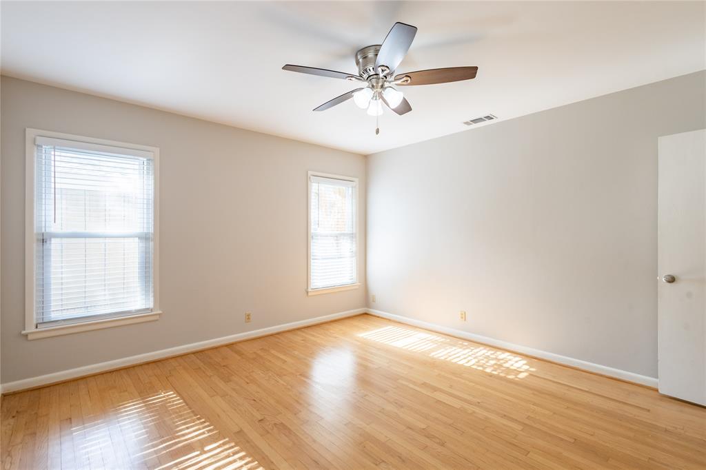 6165 Ravendale Lane Dallas, TX 75214 - Photo 29 of 40 a view of an empty room with wooden floor and a window