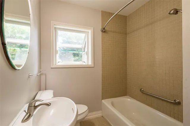 a bathroom with a sink a toilet and a shower