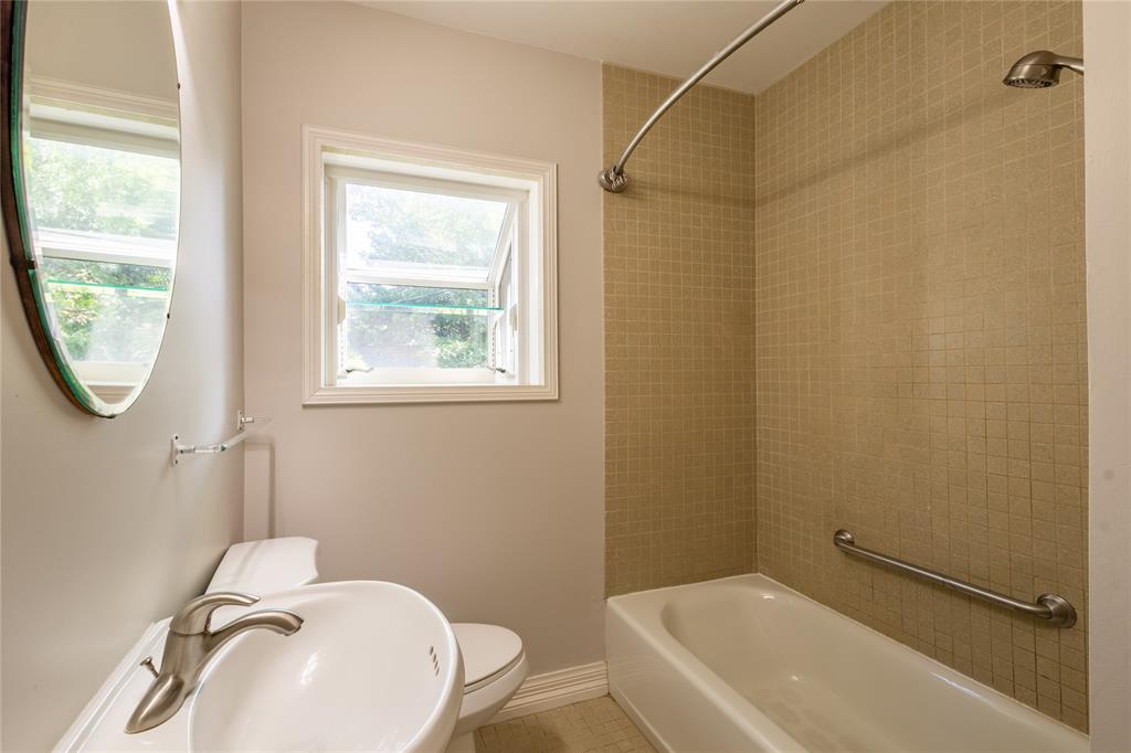 6165 Ravendale Lane Dallas, TX 75214 - Photo 31 of 40 a bathroom with a sink a toilet and a shower