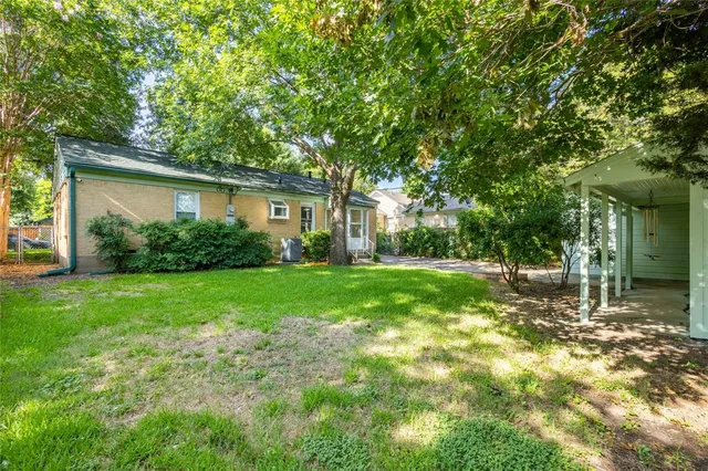 a view of backyard of house with green space