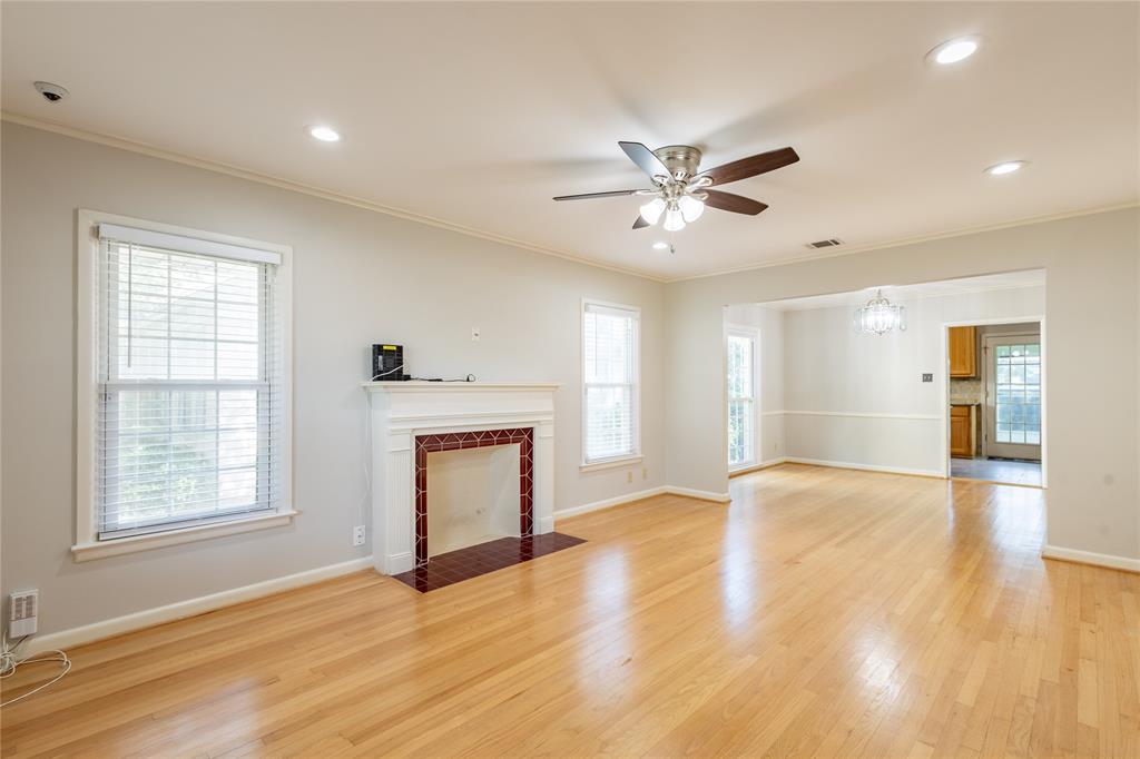 6165 Ravendale Lane Dallas, TX 75214 - Photo 4 of 40 a view of an empty room with window and wooden floor