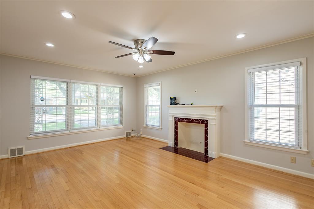 6165 Ravendale Lane Dallas, TX 75214 - Photo 7 of 40 a view of an empty room with a window and a fireplace