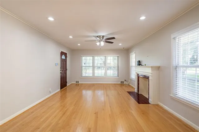 a view of an empty room with a fireplace and a window