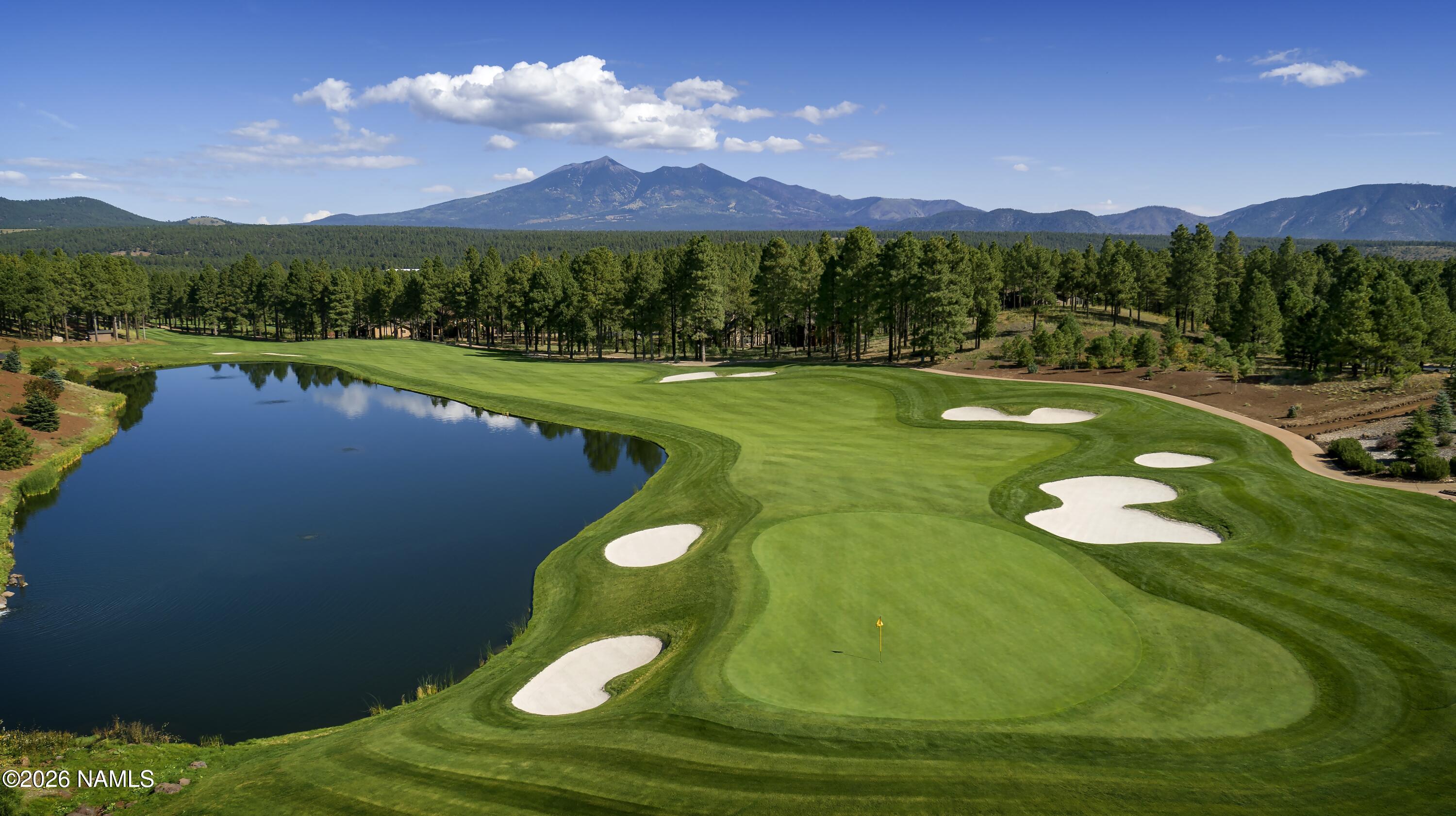 4655 Snaffle Bit Flagstaff, AZ 86005 - Photo 24 of 26 a view of a lake with a mountain in the background