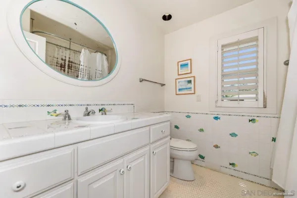 a en suite bathroom with a toilet a sink and a mirror