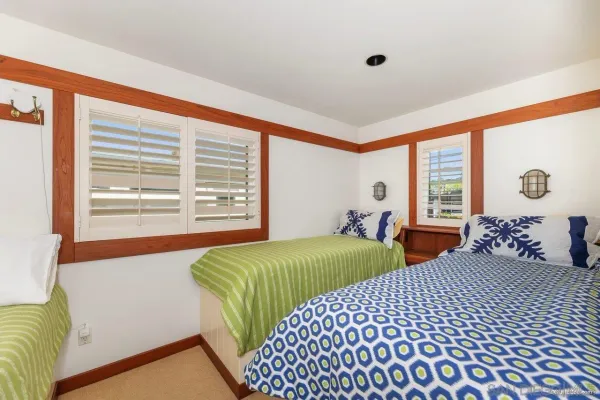 a bedroom with two beds and a large window