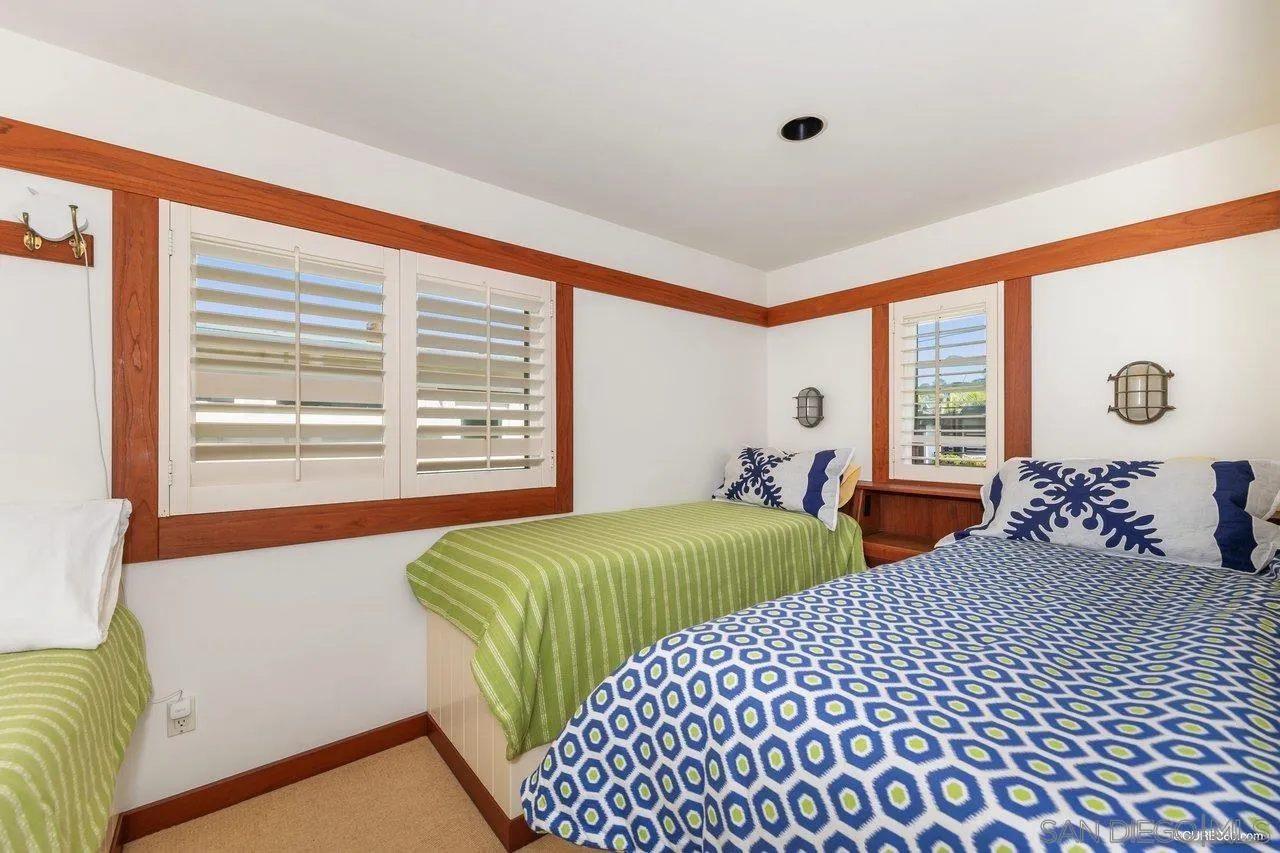 2008 Ocean Front Del Mar, CA 92014 - Photo 14 of 35 a bedroom with two beds and a large window