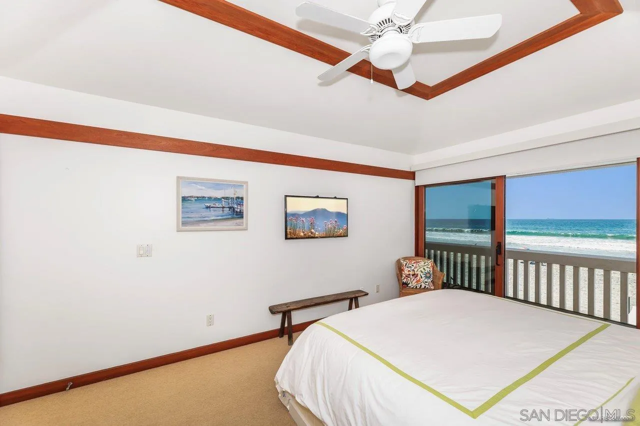 2008 Ocean Front Del Mar, CA 92014 - Photo 16 of 35 a bedroom with a bed and a large window