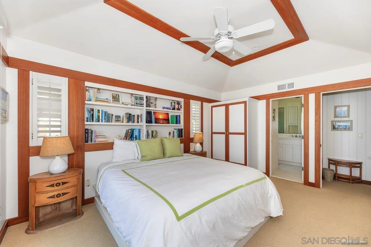 2008 Ocean Front Del Mar, CA 92014 - Photo 17 of 35 a bedroom with a large bed and a chandelier