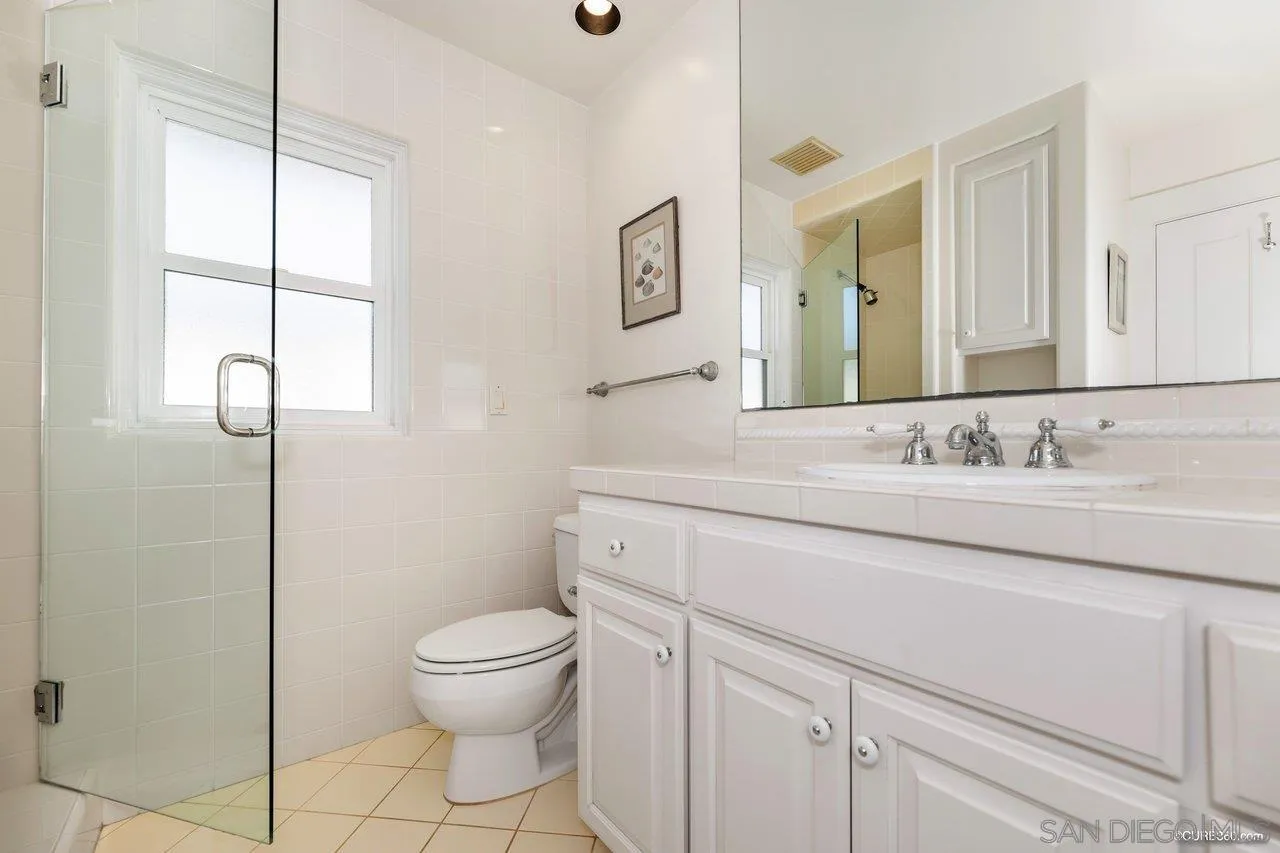 2008 Ocean Front Del Mar, CA 92014 - Photo 18 of 35 a bathroom with a granite countertop sink a toilet and a mirror