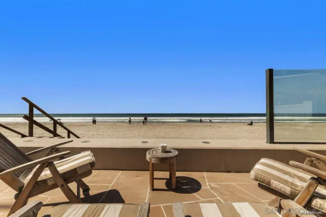 a view of a chairs and table in a balcony