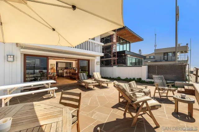a view of a patio with table and chairs with wooden floor