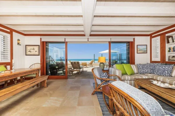 a living room with furniture and a floor to ceiling window