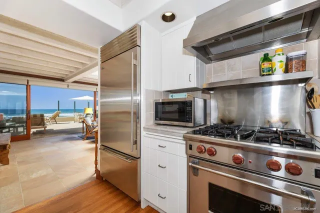 a kitchen with stainless steel appliances granite countertop a stove and a refrigerator