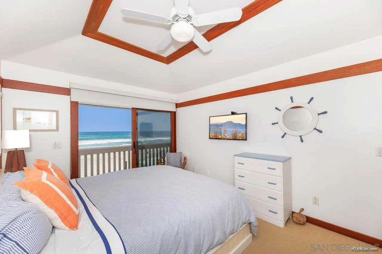 2008 Ocean Front Del Mar, CA 92014 - Photo 10 of 35 a bedroom with a bed and a dresser
