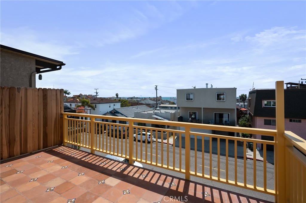 a view of a balcony with wooden floor and fence