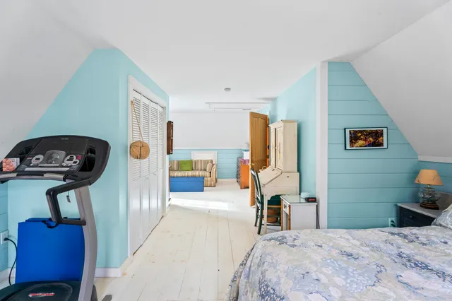 a bedroom with a bed a couch and dresser